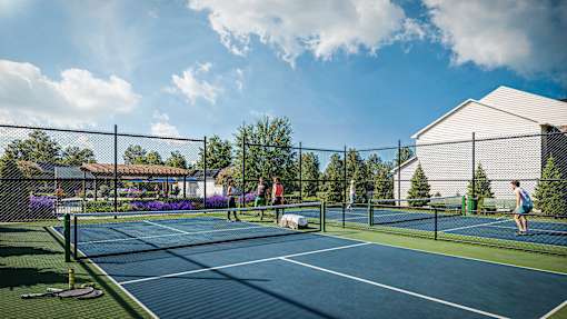 A tennis court with a person playing tennis.