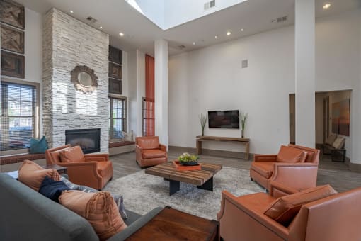 a living room with leather furniture and a fireplace