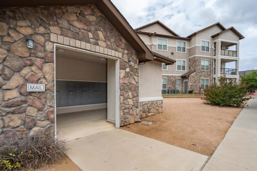 a garage door is open to a parking lot with an apartment building