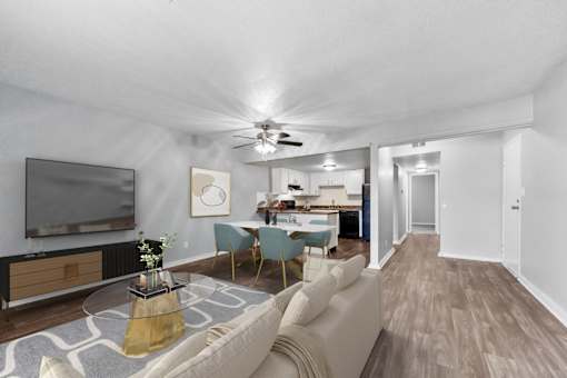 Overland Park, KS Apartments – Treetop Lodge – A living room with a television, a sofa, and a coffee table.