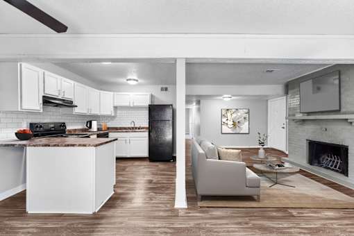 Pet-Friendly Apartments in Overland Park– Treetop Lodge – A modern kitchen with white cabinets and a black refrigerator.