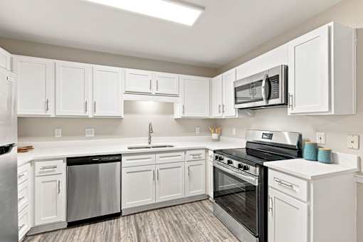 Renovated apartment kitchen with white cabinets and stainless steel appliances in Hattiesburg, MS