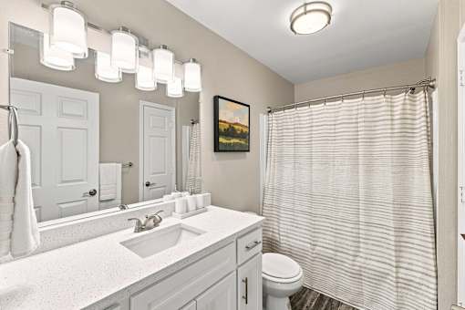Apartment bathroom with vanity and shower-tub combination at Twin Oaks in Hattiesburg