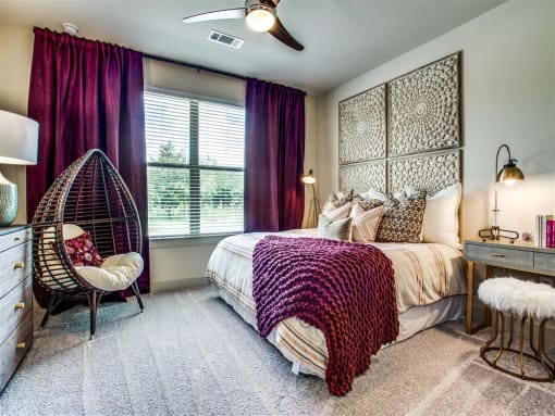 One Two and Three Bedroom Apartments in Grand Prairie, TX - Bedroom With Lush Carpeting, Large Window and Stylish Decor
