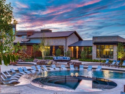 Apartments In Grand Prairie, TX For Rent - Waters Edge At Mansfield -Large Sparkling Pool Surrounded By Poolside Lounge Chairs