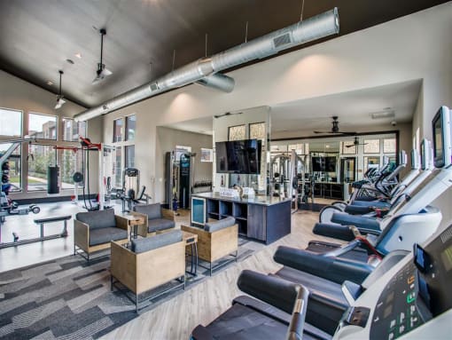 Apartments for Rent Grand Prairie TX - Fitness Center With Weight Machines, Cardio Machines, TV and Seating Area