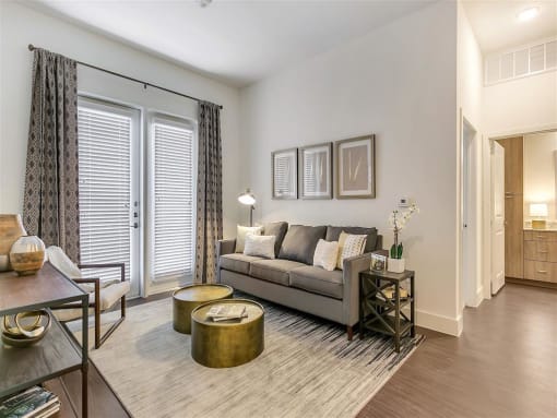 Apartments for Rent in Rowlett TX - Village of Rowlett - Living Room with Wood-Style Flooring and Entrance to Private Patio