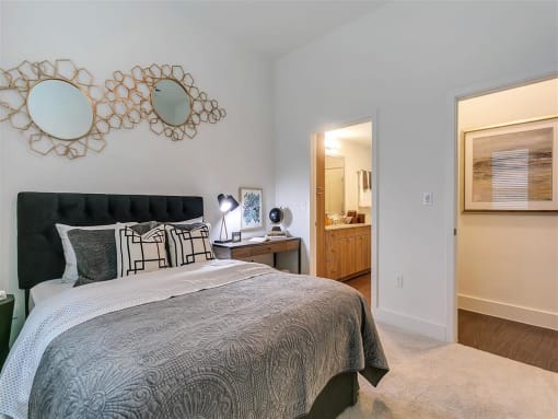 One Bedroom Apartments in Rowlett TX - Village of Rowlett - Bedroom with Plush Carpeting and an Attached Bathroom