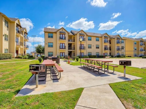 Exterior photo of Oak hollow with sand volleyball and benches and grills