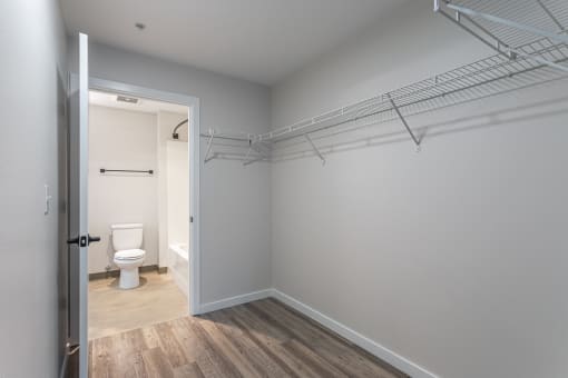 a bathroom with a toilet and a walk in closet