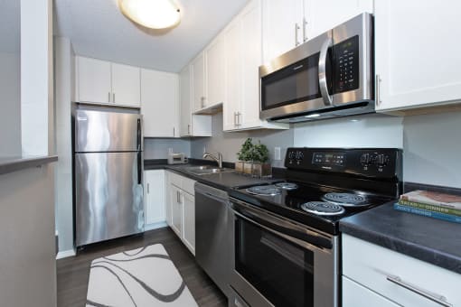 Hinton Height_Cottage Grove_MN_a kitchen with stainless steel appliances and white cabinets