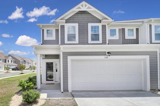 Exterior of townhome with two-car garage in Poplin Meadows, pet-friendly townhome community in Indian Trail, NC