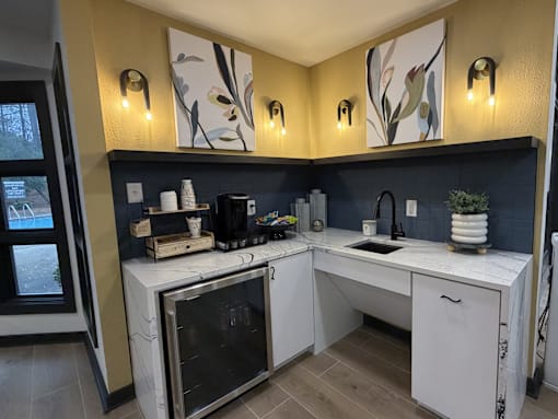 A kitchen with a white counter and a black oven.