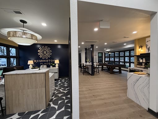 A modern interior with a reception desk and a dining area.