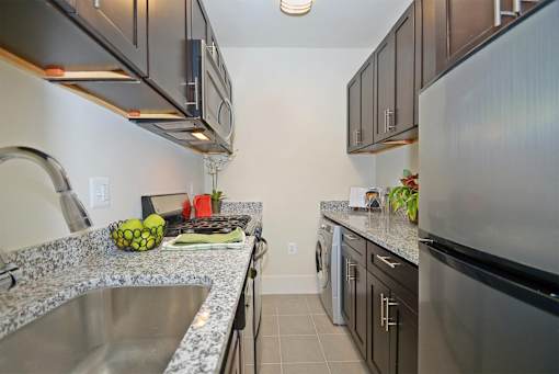 A kitchen with granite countertops and stainless steel appliances.