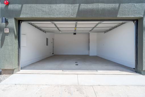 A garage with a white interior and a red light on the left side.