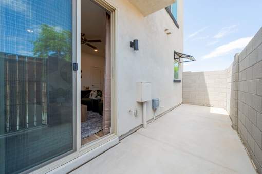 A modern house with a glass door and a white wall.