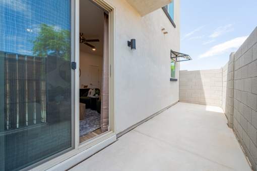 A modern house with a glass door and a tiled wall.