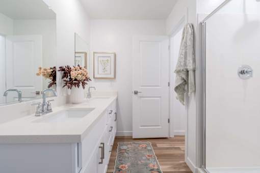 A bathroom with a white sink and a white door.