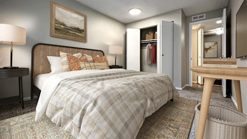 A bedroom with a bed, a desk, and a chair.