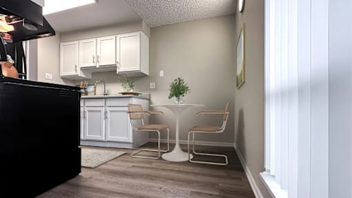 A kitchen with a black counter and white cabinets.