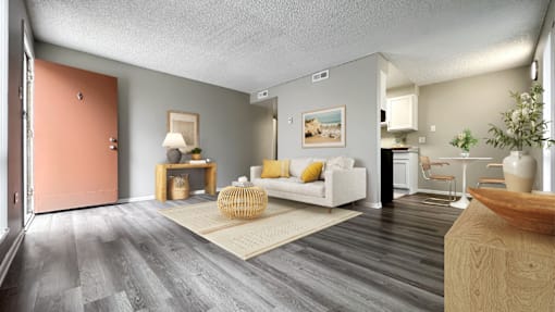 A living room with a white couch and a wooden coffee table.