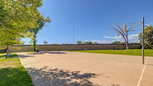 A large open parking lot with a clear blue sky above.