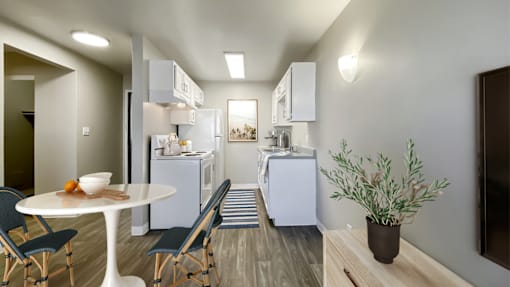 A modern kitchen with a dining table and chairs.