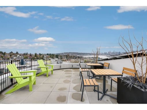 Apartments for Rent in Fremont - Inspire Fremont - Rooftop Lounge with Tables and Chairs, and a Beautiful View of the City