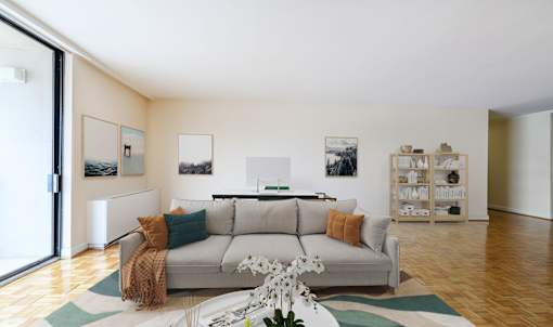 A living room with a grey couch and a white coffee table.