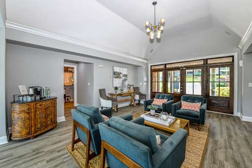 A living room with a wooden cabinet and blue couches.