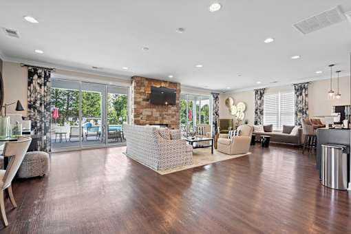 Spacious clubhouse in Hickory, NC at Hawks Landing featuring stone fireplace and hardwood floors