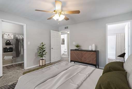 A bedroom with a bed, a dresser, and a mirror.