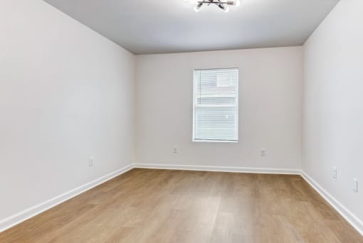 Whitney Manor Apartments in Gretna, LA photo of  bedroom with hardwood flooring and a window