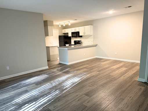 A kitchen area with a countertop and cabinets.