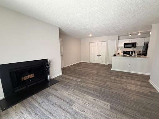 A living room with a fireplace and a television.