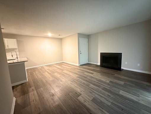 A living room with a fireplace and a television.