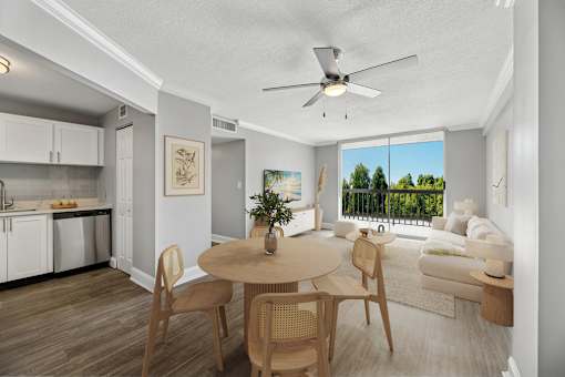 Dining area and open living space inside a renovated apartment at Wilton Tower in Wilton Manors, FL.