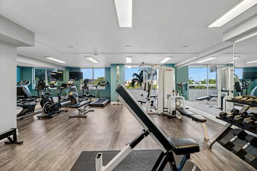 Fully equipped gym with weights and cardio machines at Wilton Tower apartments in Wilton Manors, FL.
