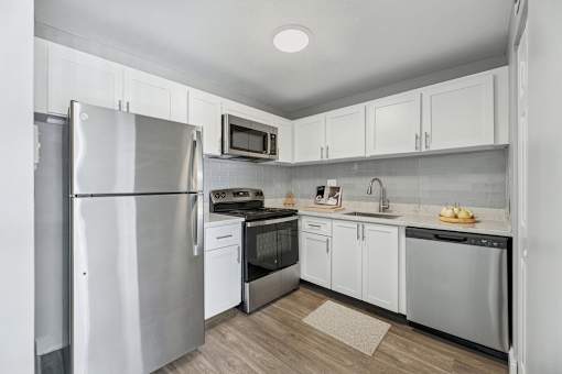 Renovated kitchen with stainless steel appliances at Wilton Tower apartments in Wilton Manors, Florida.