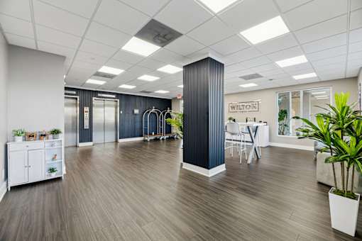 Modern leasing office and lobby entrance at Wilton Tower apartments in Wilton Manors, Florida.