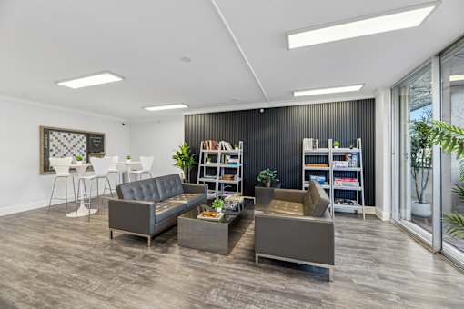 Resident lounge with modern seating and entertainment space at Wilton Tower in Wilton Manors, Florida.