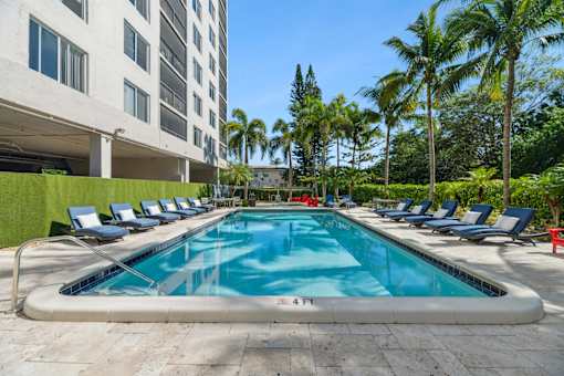 Resort-style swimming pool with sundeck at Wilton Tower pet-friendly apartments in Wilton Manors, FL.