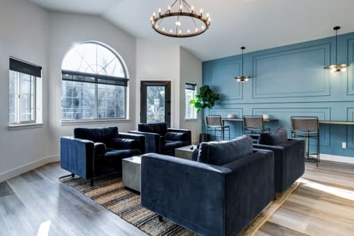a living room with blue walls and a chandelier