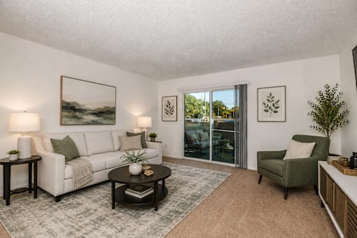 A living room with a couch, chair, and coffee table.
