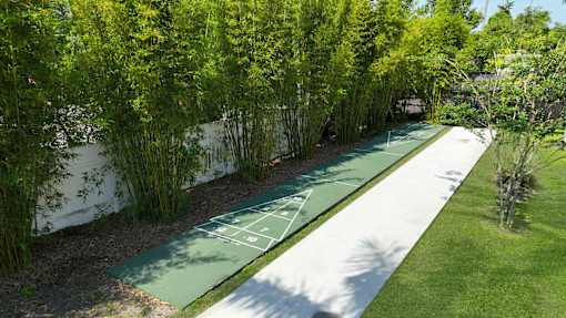 landscaped walkway and shuffle board at Woodlake Villas apartments in Orlando Florida