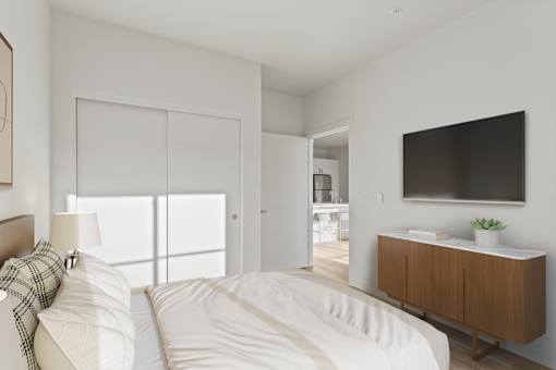 A modern bedroom with a large bed and a flat screen TV mounted on the wall.