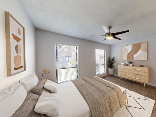a bedroom with a large bed and a ceiling fan