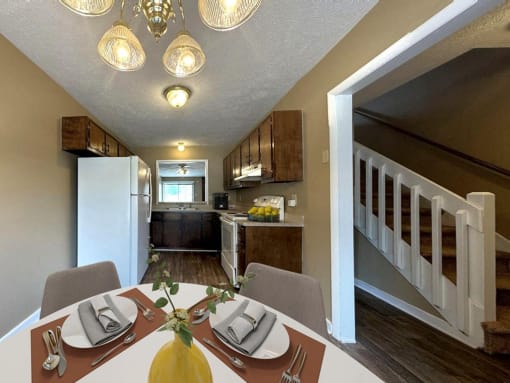 a dining room table with a kitchen in the background