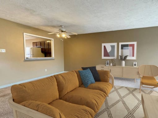 a living room with a couch and a ceiling fan